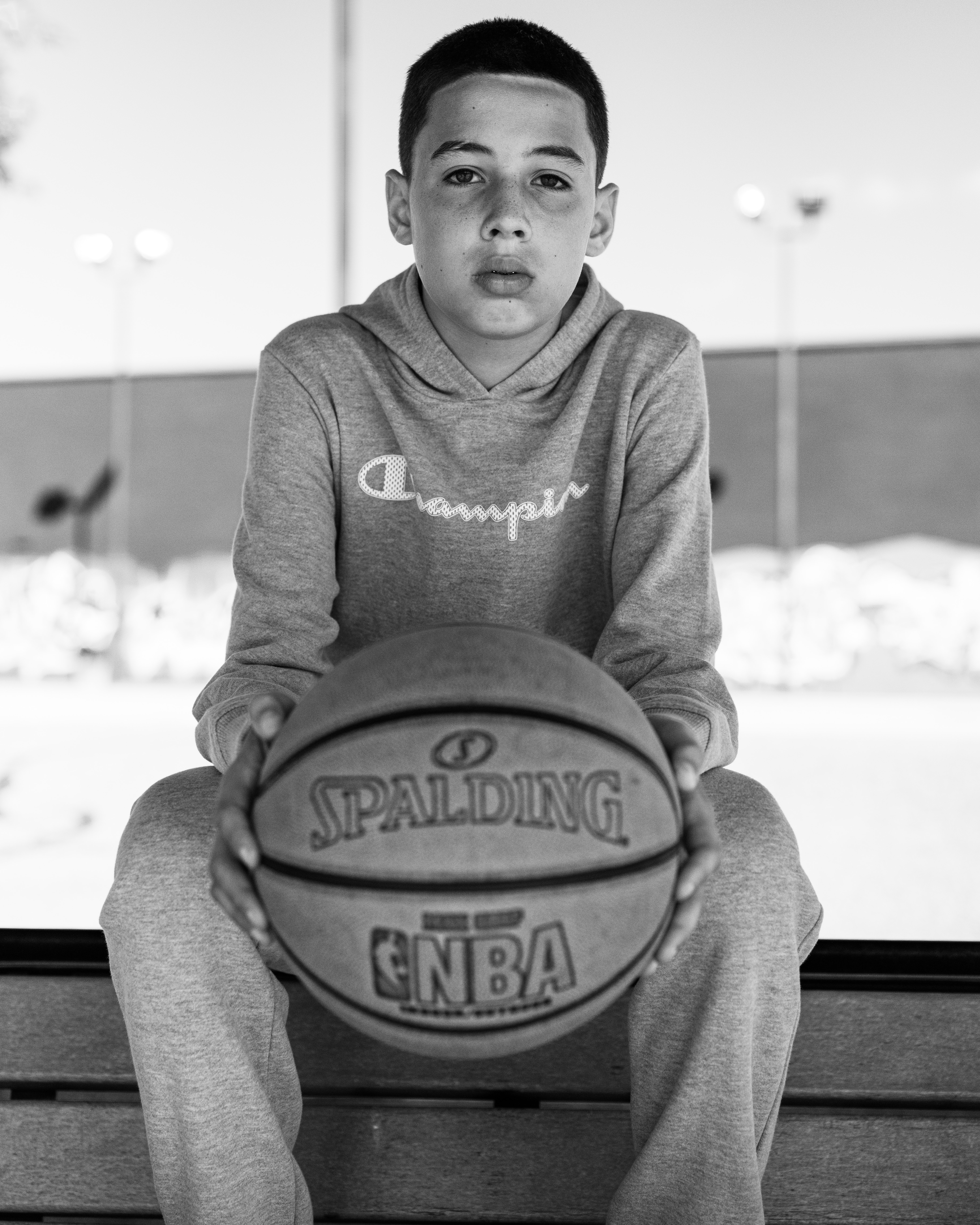 a-boy-seated-holding-a-basket-ball-2915307